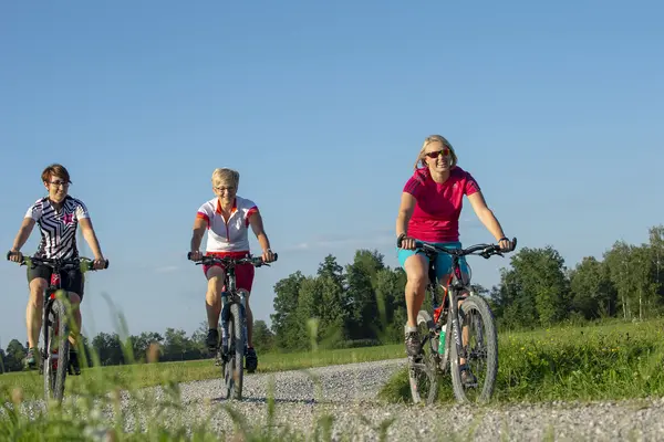 Fahrradfahrerinnen auf dem Weg durchs Moos